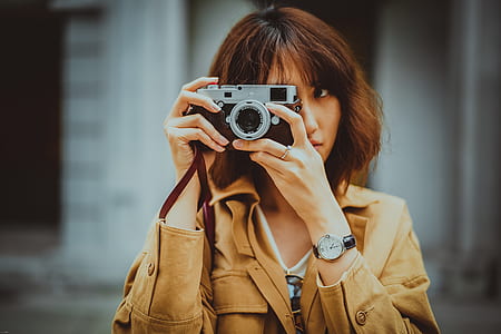 woman taking photo using camera thumbnail