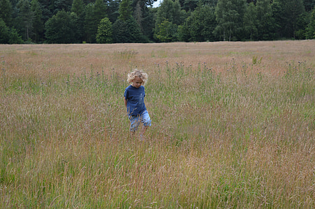toddler standing in the middle of grass thumbnail
