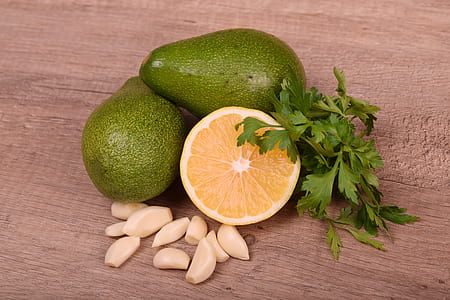 two green avocados and sliced lemon thumbnail