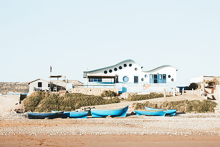 blue canoes on shoreline thumbnail