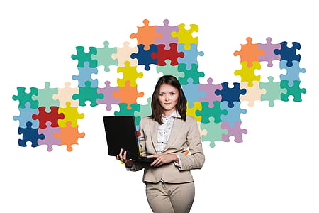 woman wearing beige suit holding black laptop computer thumbnail
