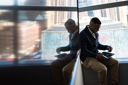 Man Sitting Beside Window thumbnail