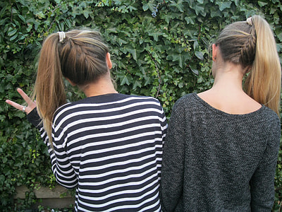 two women stares at leaves on wall thumbnail