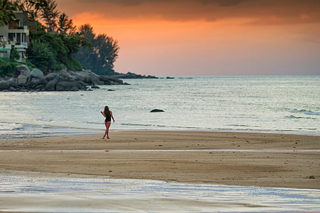 woman walking on seashore thumbnail