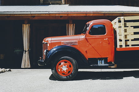 red and brown truck parked beside house thumbnail