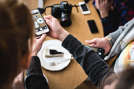 Girl shooting cake with her iPhone thumbnail