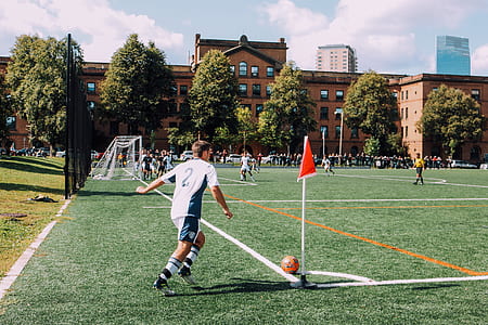 man about to kick ball on corner of soccer field thumbnail