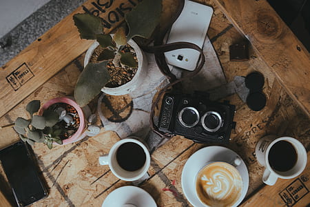 white ceramic mug with coffee on table thumbnail