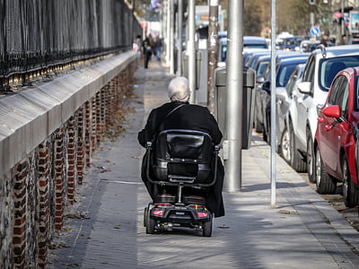 woman sitting on motorized wheelchair on pathway thumbnail