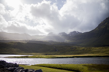 sunlight over green mountains and body of water thumbnail