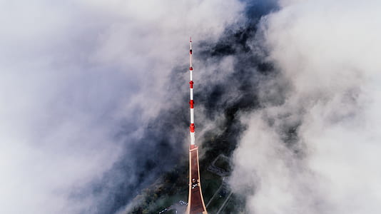 Aerial Photography of Red and White Striped Tower Near Clouds thumbnail