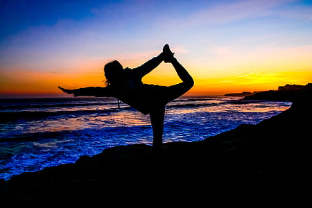 silhouette photo of woman doing yoga during sunset thumbnail