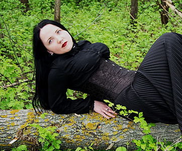 woman reclining on tree trunk thumbnail