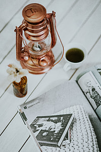 Magazine with a paraffin lamp on a white table thumbnail