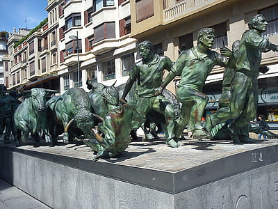 green concrete men and bulls sculpture thumbnail