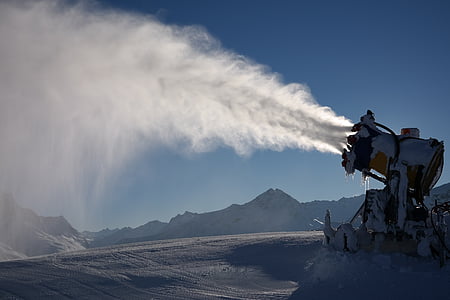 white machine emitting white smoke near mountains during daytime thumbnail