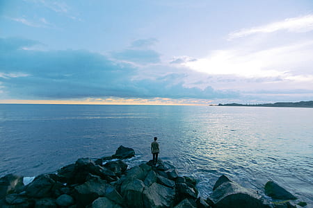person standing near body of water thumbnail