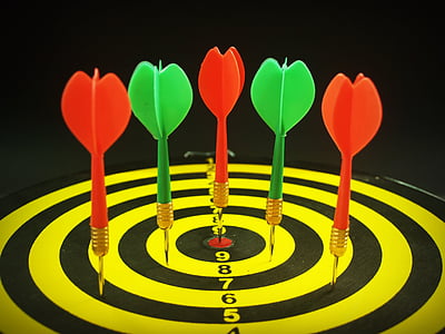 three green and three red dart pins on dartboard thumbnail