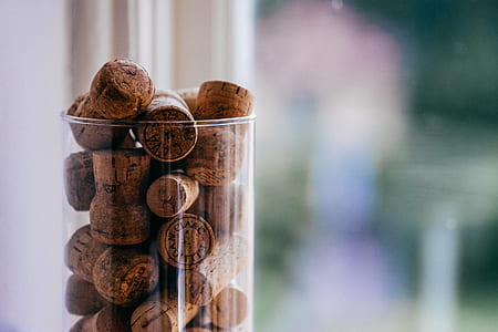 selective focus photography of cork stopper in clear glass container thumbnail