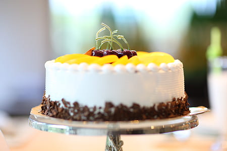 White Round Cake Topped With Yellow Slice Fruit thumbnail