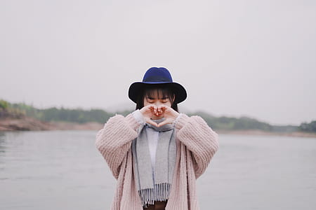 woman doing heart hand sign thumbnail