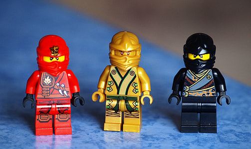 three Lego red, gold, and black action figures thumbnail