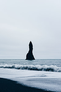 rock monolith on body of water thumbnail