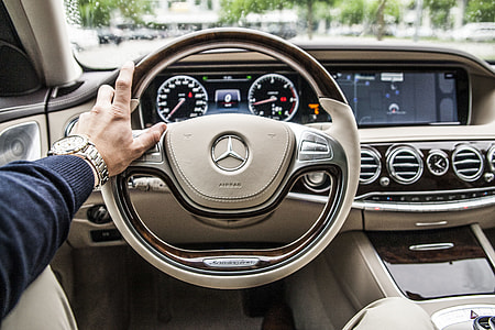 person sitting inside Mercedes-Benz car holding steering wheel thumbnail