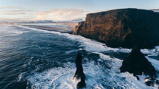 body of water near rock formations thumbnail