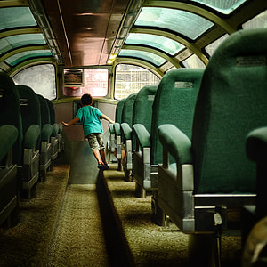 boy inside bus holding chair thumbnail