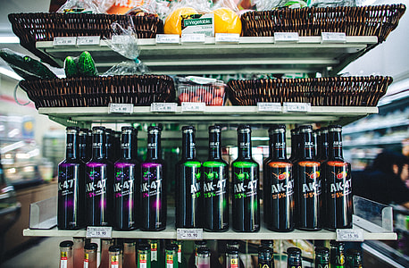 liquor bottles on white shelf thumbnail