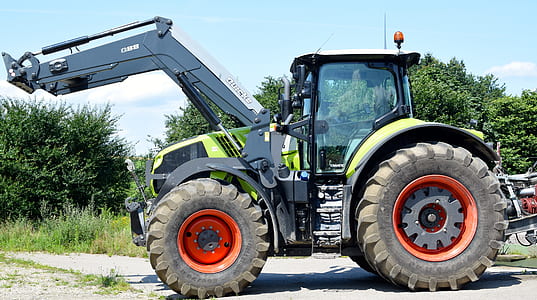 white and green payloader at daytime thumbnail