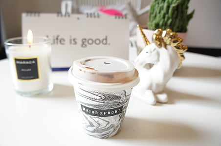 white and black plastic cup near white unicorn ceramic figurine thumbnail