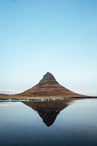 brown mountain reflected on water during daytime thumbnail