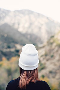 shallow focus photography of person facing mountains during daytime thumbnail