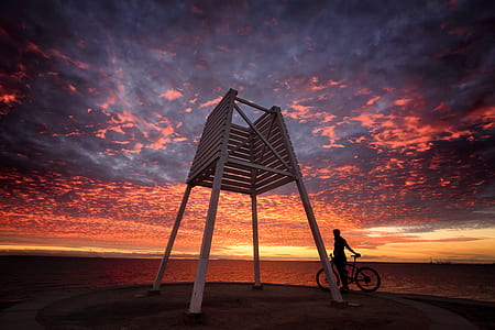 low angel photography of lifeguard chair under golden hour thumbnail
