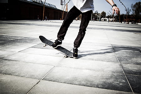 person skating on gray ground under blue sky thumbnail
