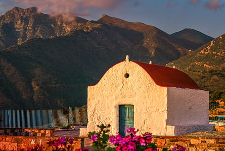 white concrete building near mountains thumbnail