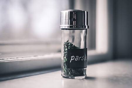 green parsley bottle on white surface thumbnail