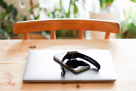 laptop, phone, and watch on table thumbnail