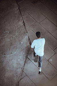 man skateboarding on gray floor thumbnail
