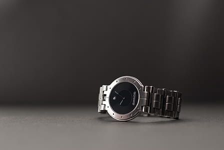 analog watch on gray surface thumbnail