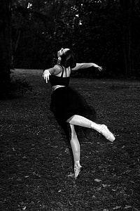 grayscale photography of ballerina woman dancing on forest thumbnail