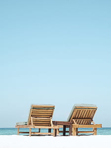 two brown loungers on beach thumbnail