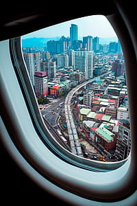 Aerial View of City Through Airplane Window thumbnail