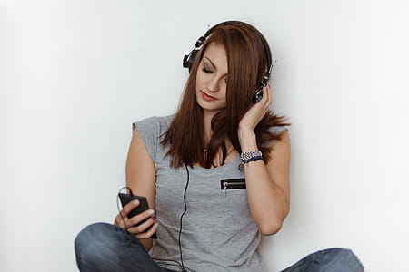 Beautiful young woman in headphones listening to music thumbnail