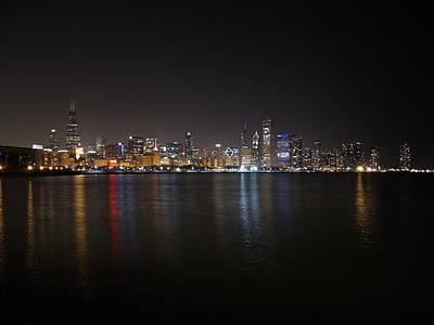 city escape photography of high-rise buildings at nighttime thumbnail