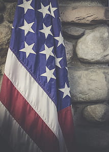 American flag in front of wall thumbnail