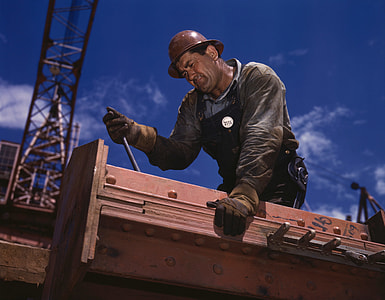 man in gray long-sleeved top wearing brown hard hat during daytime thumbnail