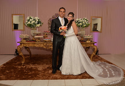 man and woman standing next to table thumbnail